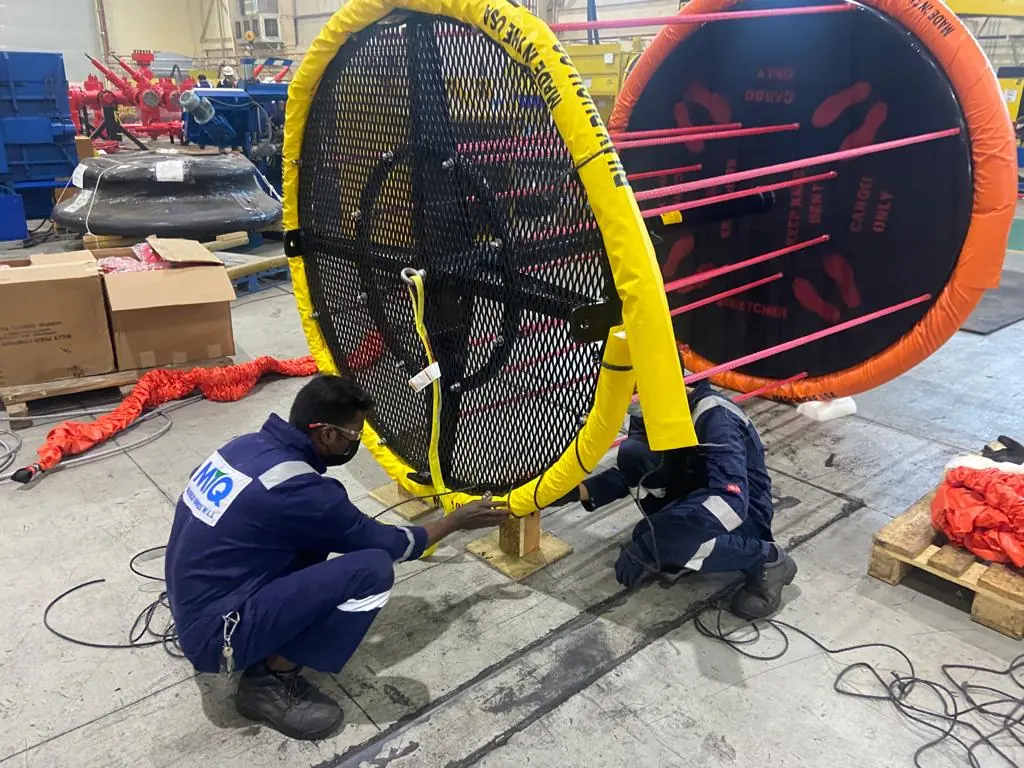Technicians reassembling an X-904 float and frame during refurbishment